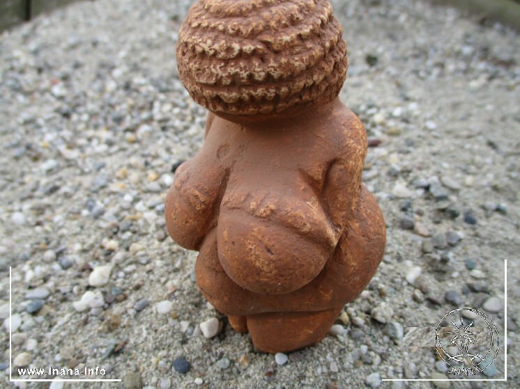 Göttinfigurine in Sand gesteckt